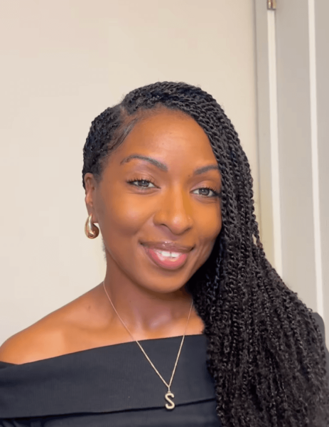 Black girl wearing mini twists with a side part